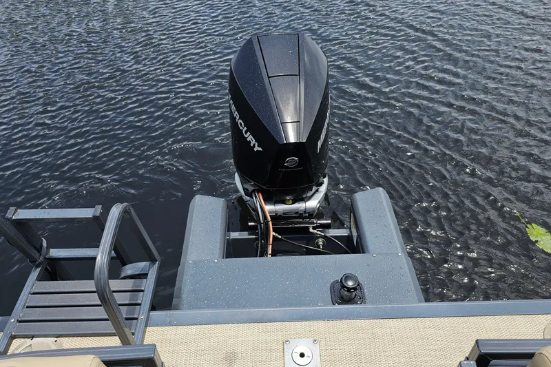 Slide: The Image of 2020 Regency 230 LE3 boat with Mercury outboard motor on water. - 31