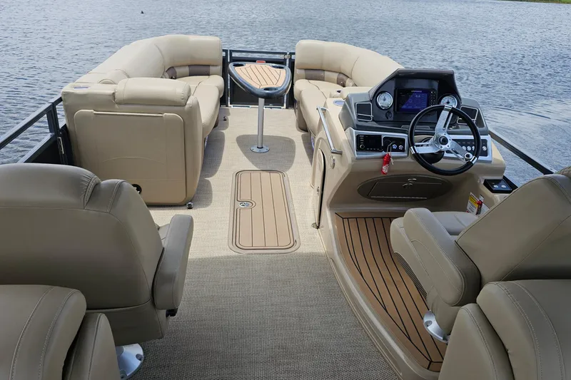 Slide: The Image of Luxurious 2020 Regency 230 LE3 pontoon boat interior with plush seating and modern dashboard. - 33
