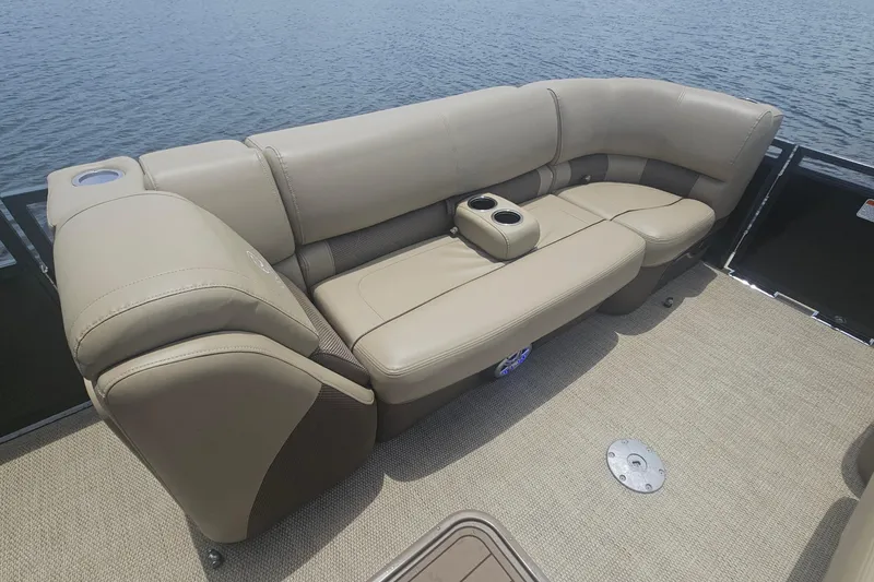 Slide: The Image of Luxurious seating on 2020 Regency 230 LE3 pontoon boat with cup holders, near water. - 35