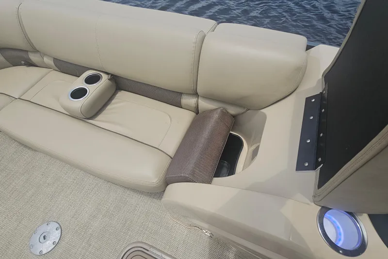 Slide: The Image of 2020 Regency 230 LE3 boat interior with beige seating and cup holders. - 42