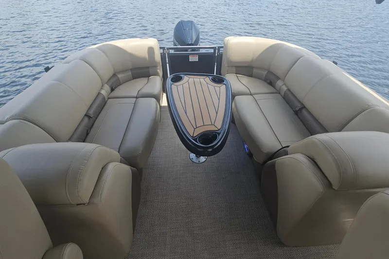 Slide: The Image of Luxurious seating on a 2020 Regency 230 LE3 pontoon boat with a stylish table. - 45