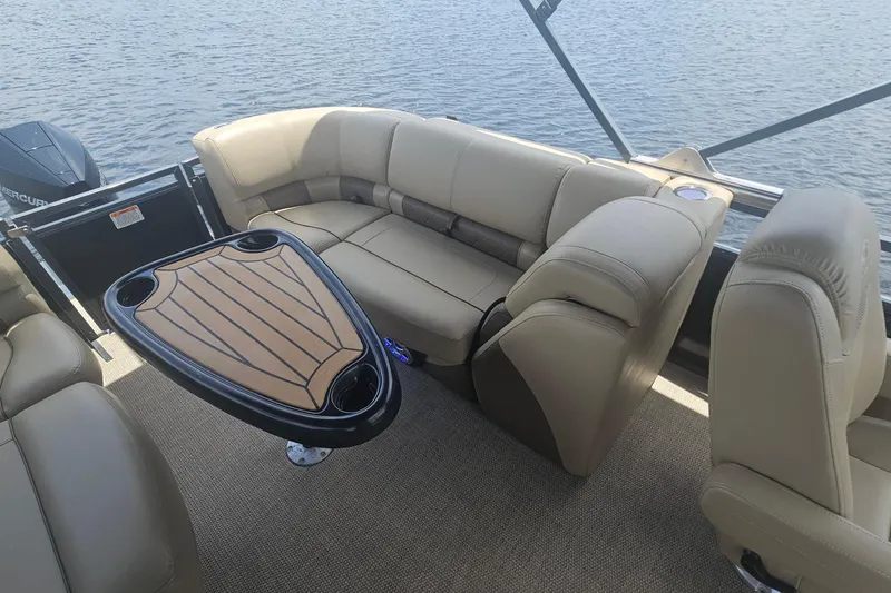 Slide: The Image of Luxurious seating area on a 2020 Regency 230 LE3 pontoon boat with a stylish table. - 47