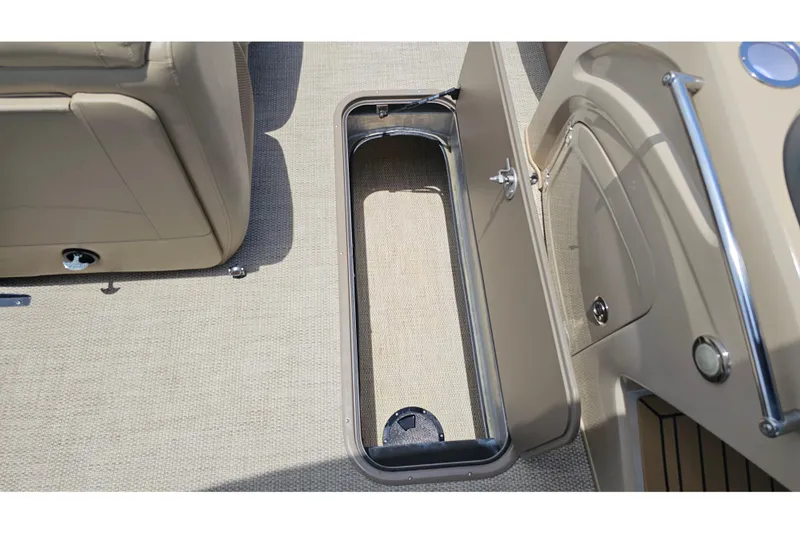 Slide: The Image of Storage compartment on a 2020 Regency 230 LE3 boat, featuring beige interior and sleek design. - 52