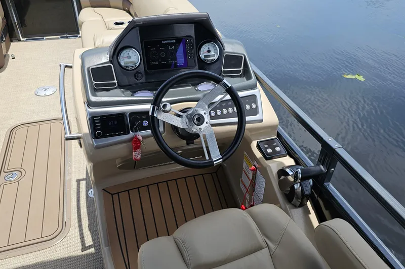 Slide: The Image of Steering console of 2020 Regency 230 LE3 boat with modern controls and navigation system. - 53