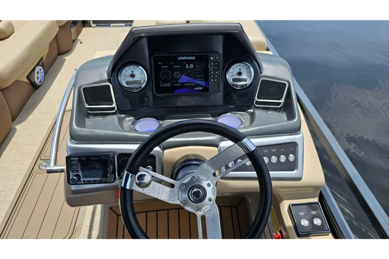 Slide: The Image of Steering console of 2020 Regency 230 LE3 boat with navigation display and gauges. - 55