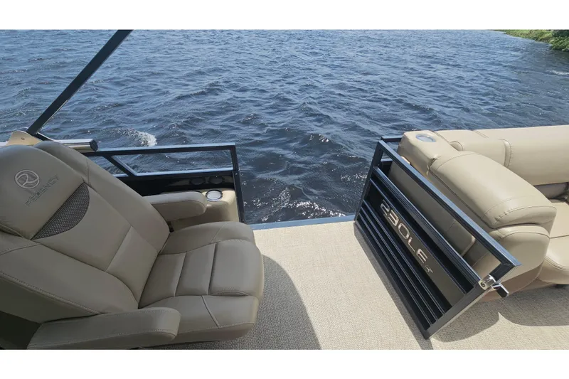 Slide: The Image of Luxurious 2020 Regency 230 LE3 pontoon boat interior with plush seating by the water. - 61