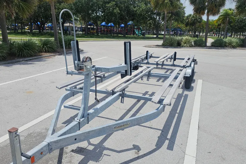 Slide: The Image of Boat trailer for Regency 230 LE3, 2020 model, parked in a sunny lot. - 64
