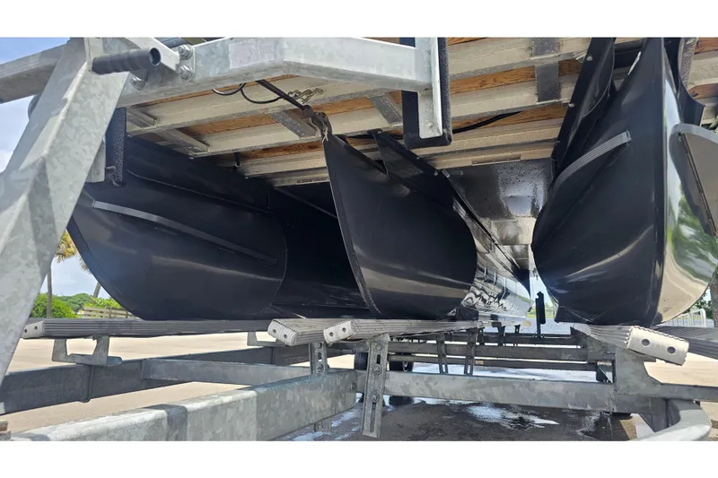 Slide: The Image of Underneath view of a 2020 Regency 230 LE3 pontoon boat on a trailer. - 67