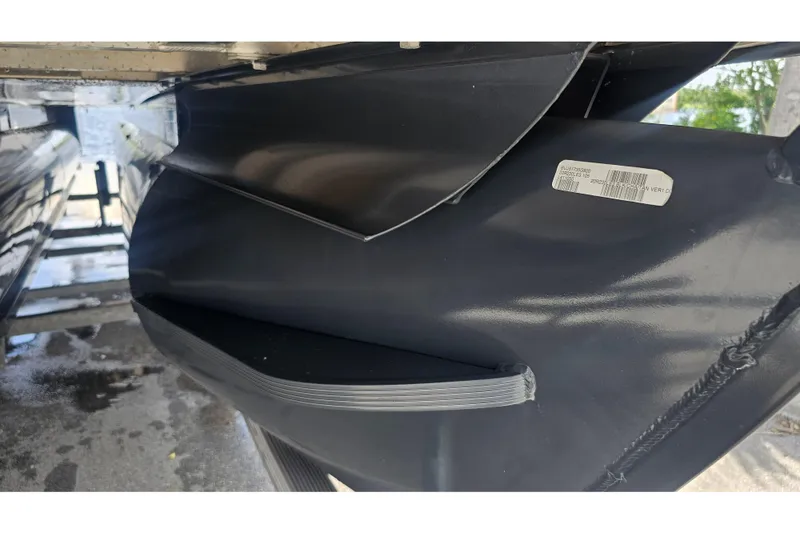 Slide: The Image of Close-up of a 2020 Regency 230 LE3 pontoon boat's underside, showcasing sleek design and structure. - 68