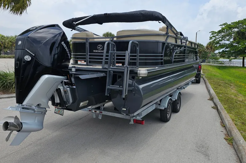 Slide: The Image of 2020 Regency 230 LE3 pontoon boat on trailer with Mercury Verado engine. - 7
