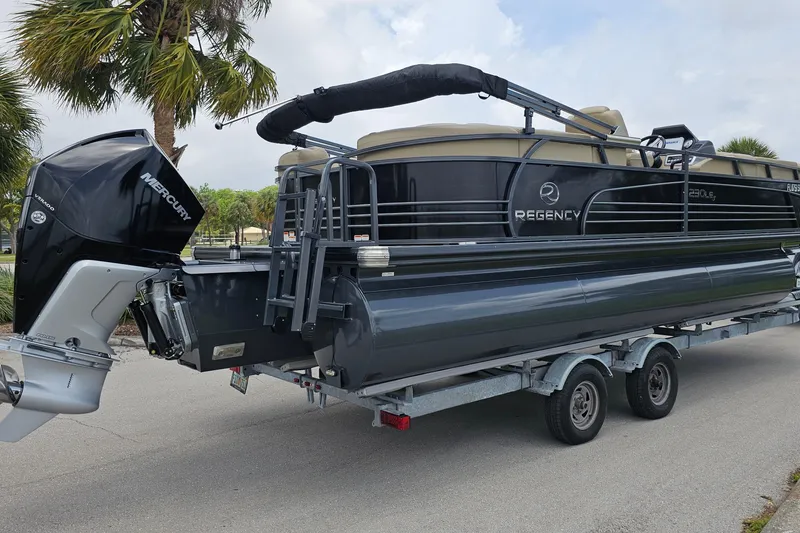 Slide: The Image of 2020 Regency 230 LE3 pontoon boat on trailer with Mercury outboard motor. - 8
