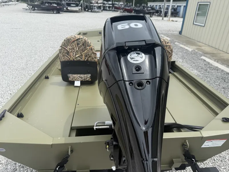 Slide: The Image of 2026 Lowe Roughneck 1650SC with 60 HP motor, green seats outdoors. - 4
