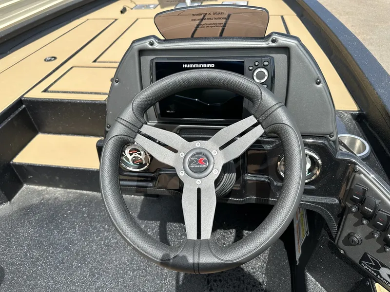 Slide: The Image of Steering wheel and dashboard of the 2026 Xpress H20C Crappie boat. - 7