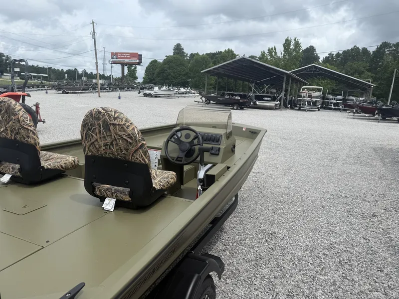Slide: The Image of 2026 Lowe Roughneck 1650SC boat on gravel lot with camo seats. - 2