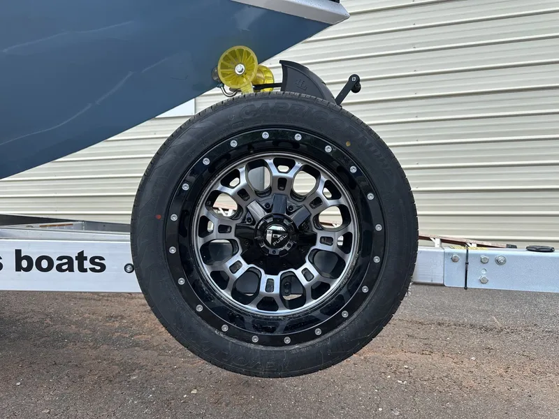 Slide: The Image of 2026 Xpress XR 21 BAY boat trailer with stylish wheel. - 2