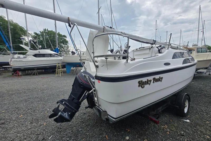 Slide: The Image of 2005 MacGregor 26 sailboat named "Hanky Panky" on a trailer in a boatyard. - 5