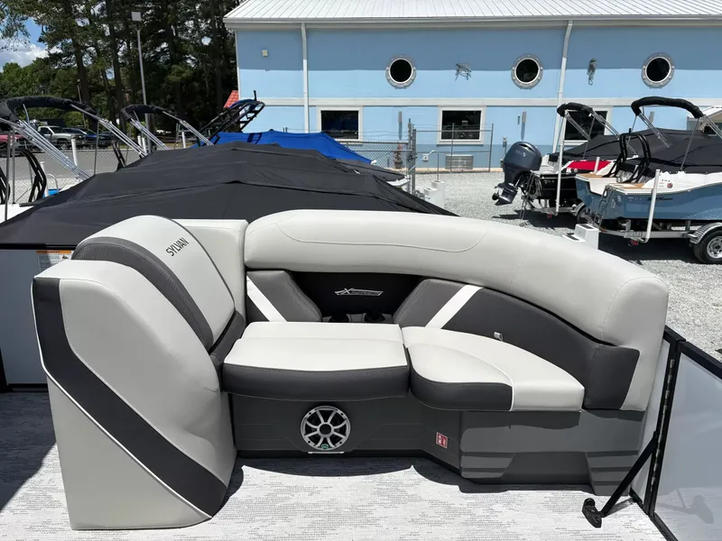 Slide: The Image of Sylvan X-3 DLZ BAR 2026 boat seating at a marina. - 6