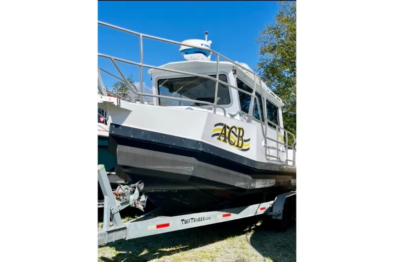 The Image of 2008 ACB 28 Explorer boat on trailer, white exterior, parked outdoors. - 1