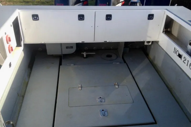 Slide: The Image of Interior view of a 2008 ACB 28 Explorer boat, featuring storage compartments. - 10