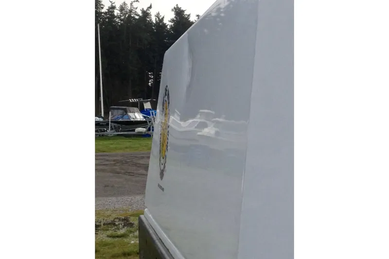 Slide: The Image of Side view of a 2008 ACB 28 Explorer boat with a dented surface. - 11