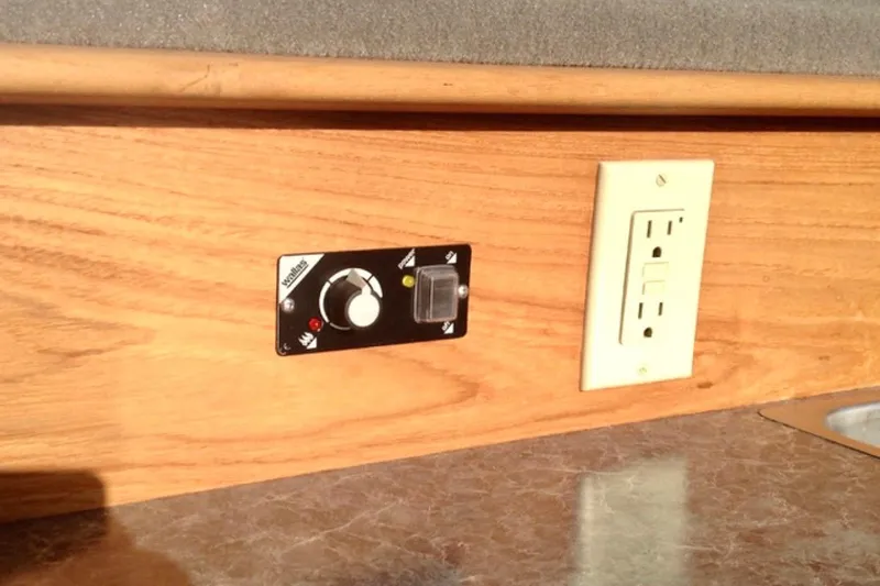 Slide: The Image of Wooden countertop with electrical outlet and control panel in ACB 28 Explorer, 2008 model. - 12