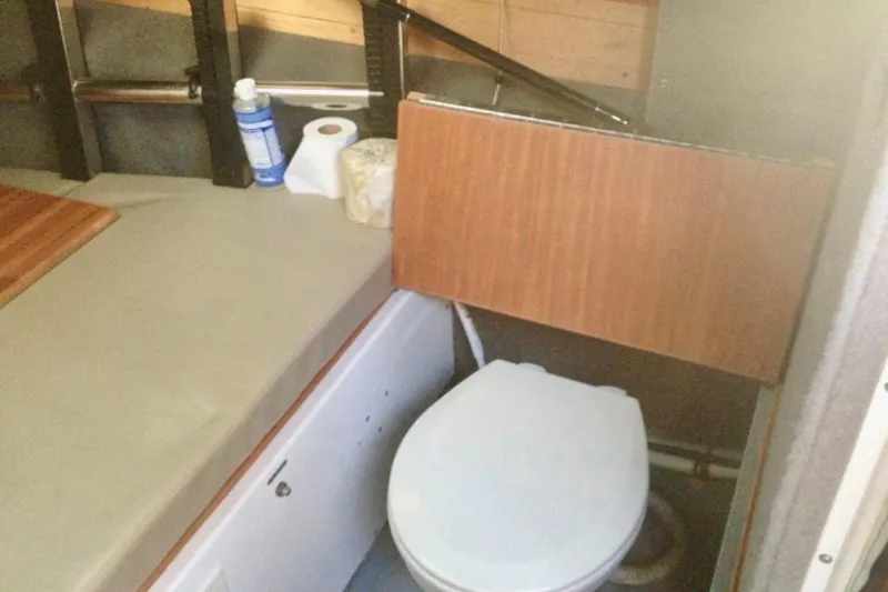 Slide: The Image of Compact boat interior with toilet, storage, and essentials in a 2008 ACB 28 Explorer. - 13