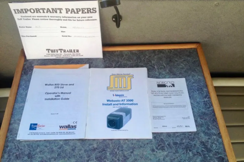Slide: The Image of Manuals and important papers for ACB 28 Explorer 2008 on a table. - 15