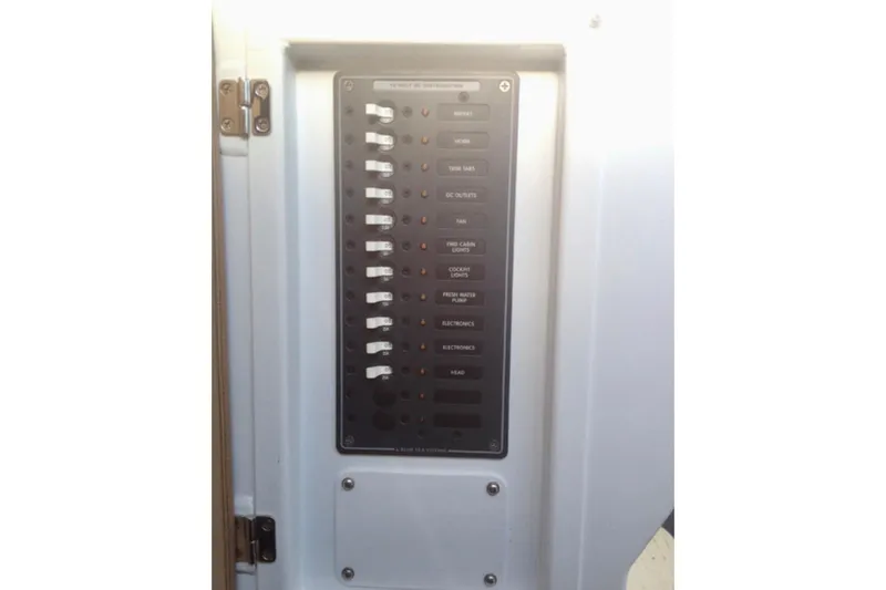 Slide: The Image of Electrical panel of a 2008 ACB 28 Explorer boat with labeled switches. - 18