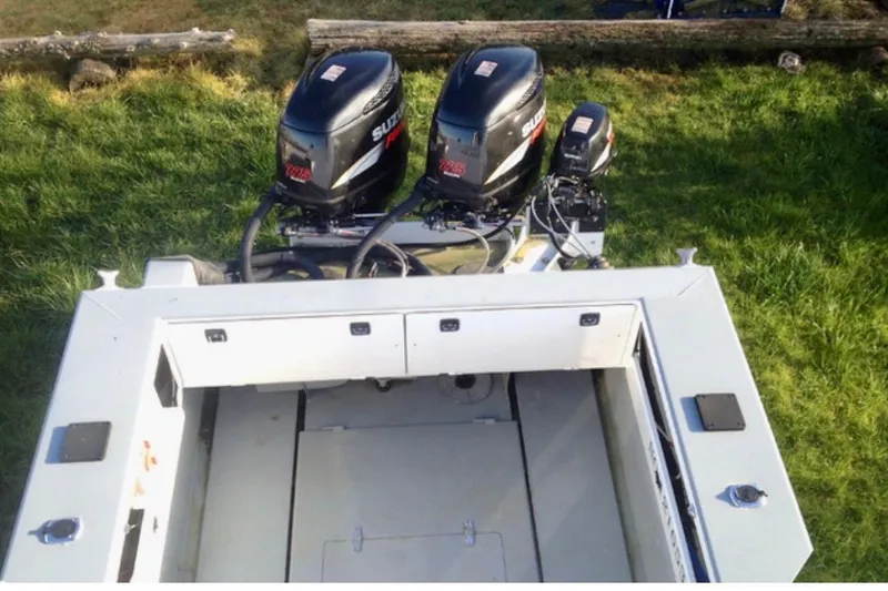 Slide: The Image of ACB 28 Explorer 2008 boat with dual Suzuki outboard motors on grassy area. - 5
