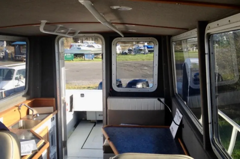 Slide: The Image of Interior of 2008 ACB 28 Explorer boat with kitchenette and seating area. - 9