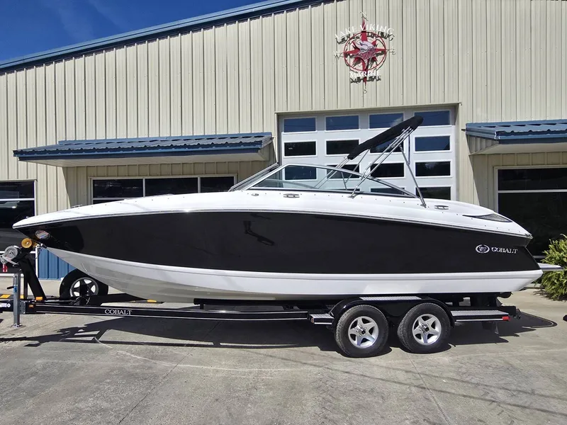 The Image of 2006 Cobalt 232 boat on trailer in front of warehouse. - 1