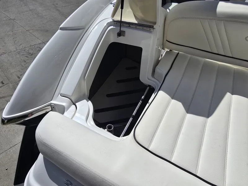 Slide: The Image of Interior of a 2006 Cobalt 232 boat with white upholstery. - 10