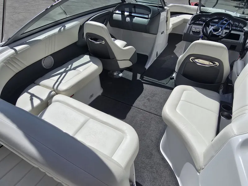 Slide: The Image of Interior of a 2006 Cobalt 232 boat with white leather seating. - 11