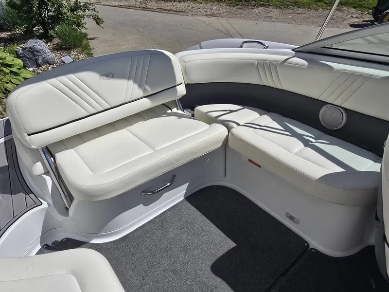 Slide: The Image of Interior of a 2006 Cobalt 232 boat with white leather seating. - 13