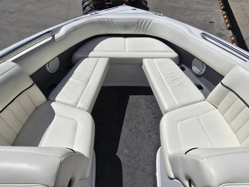 Slide: The Image of Interior of a 2006 Cobalt 232 boat with white leather seating. - 18