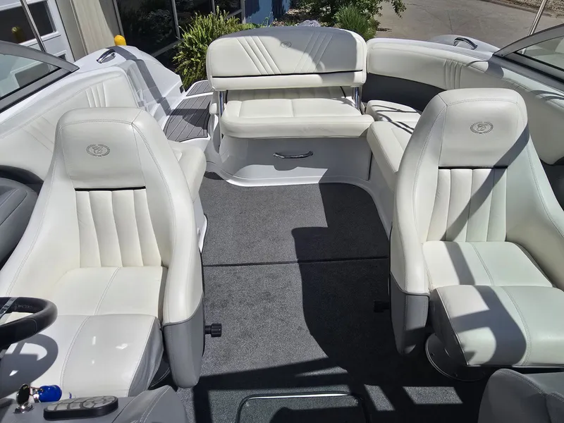 Slide: The Image of Interior of a 2006 Cobalt 232 boat with white leather seats. - 21