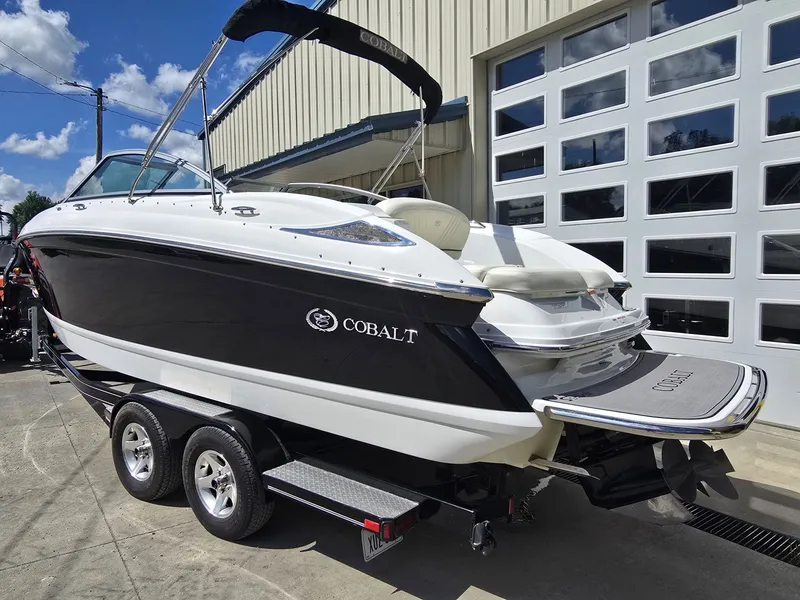 Slide: The Image of 2006 Cobalt 232 boat on trailer outside garage. - 3