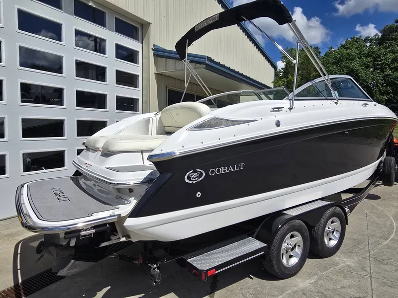 Slide: The Image of 2006 Cobalt 232 boat on trailer outside garage. - 5