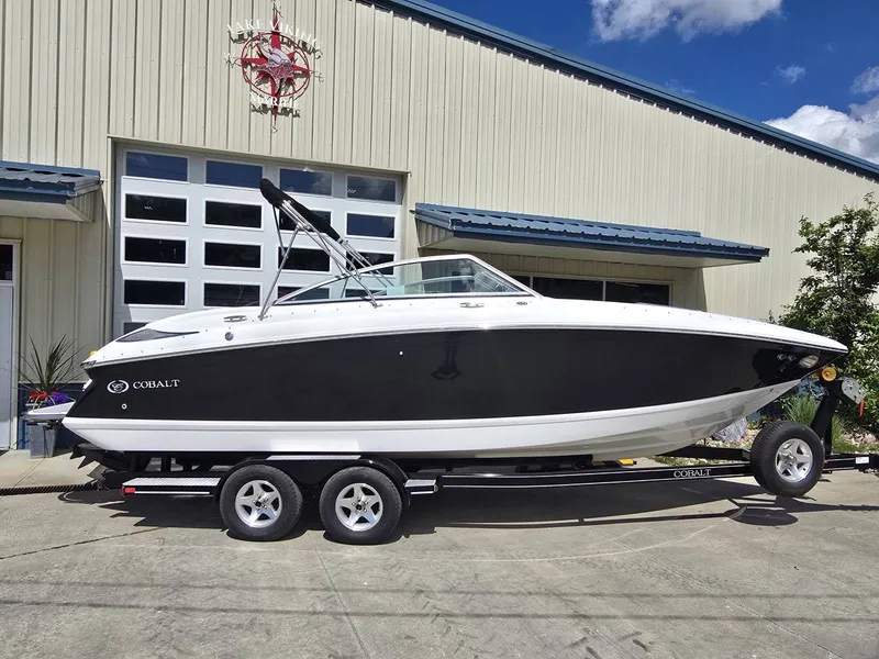 Slide: The Image of 2006 Cobalt 232 boat on trailer in front of building. - 6