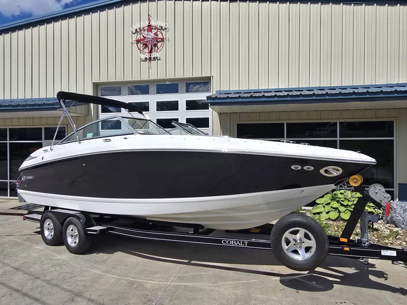 Slide: The Image of 2006 Cobalt 232 boat on trailer in front of building. - 7