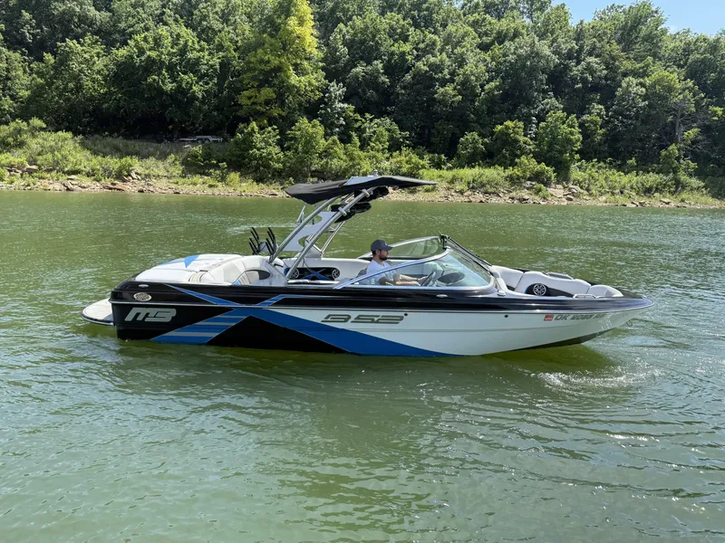 Slide: The Image of 2013 MB SPORTS B52 boat on a calm lake. - 2