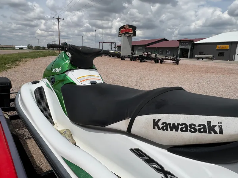 Slide: The Image of 2003 Kawasaki 1200 STX-R Jet Ski on trailer in front of store. - 3