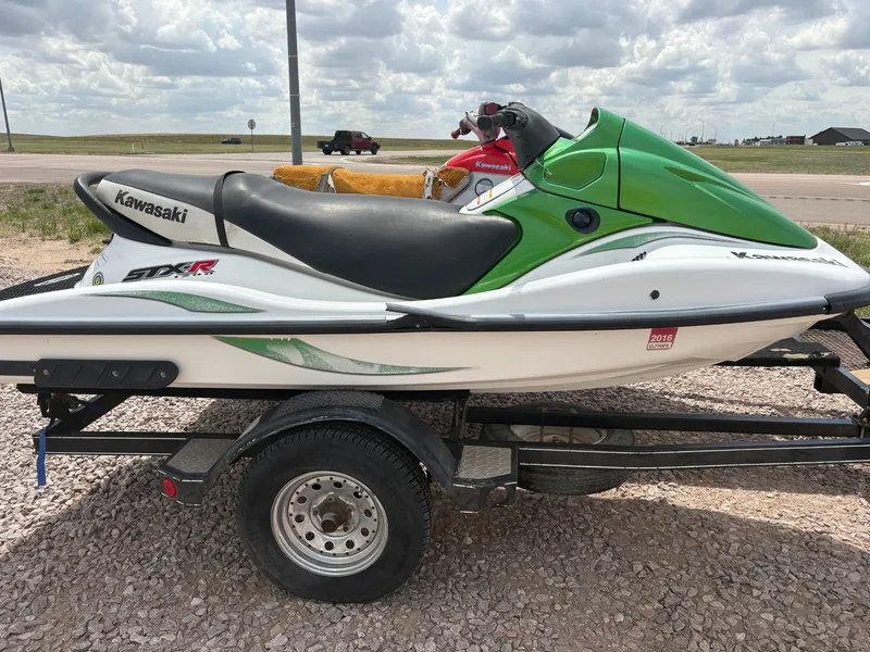 Slide: The Image of 2003 Kawasaki 1200 STX-R jet ski on trailer, green and white design. - 5