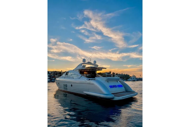 The Image of Luxury 2009 Azimut 68S yacht on serene water at sunset, showcasing sleek design. - 1