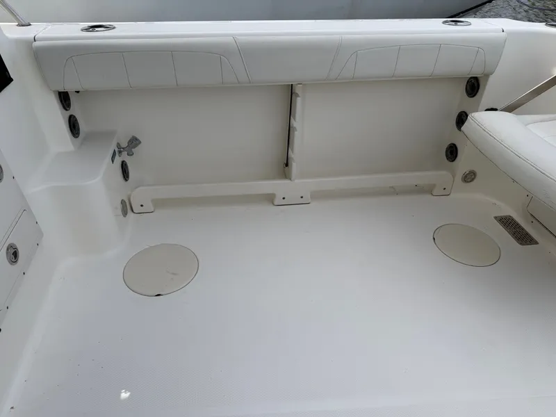 Slide: The Image of Interior of a 2016 World Cat 320 EC boat, white seating area. - 11
