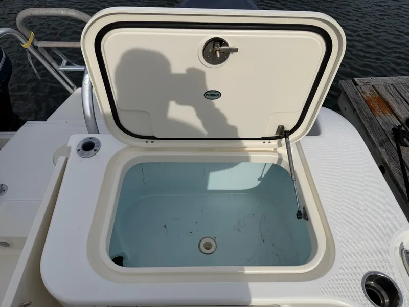 Slide: The Image of 2016 World Cat 320 EC boat with open storage compartment lid. - 12