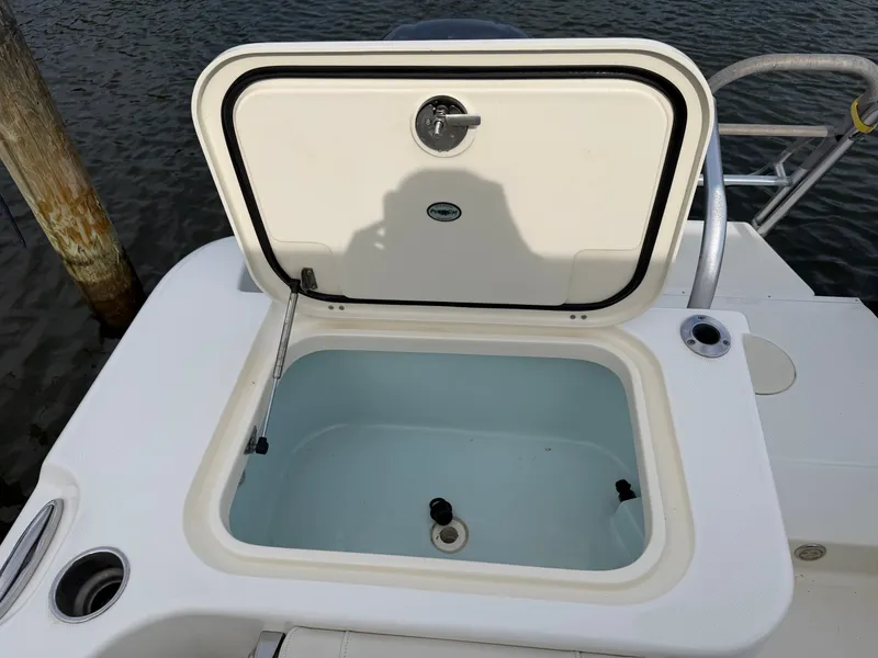 Slide: The Image of 2016 World Cat 320 EC boat with open storage compartment lid. - 16