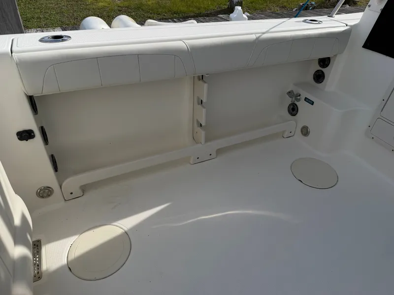 Slide: The Image of Interior of a 2016 World Cat 320 EC boat, white seating area. - 18