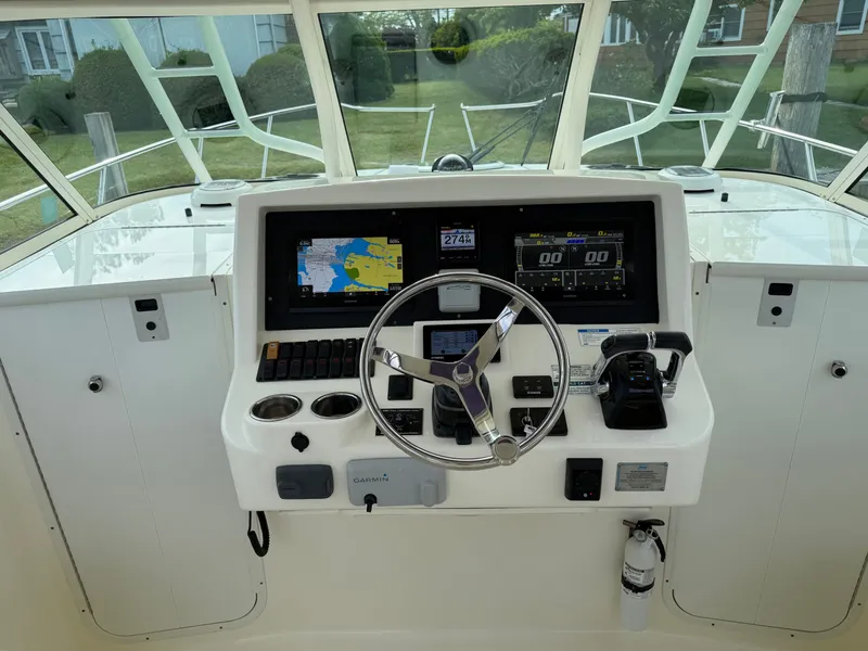 Slide: The Image of 2016 World Cat 320 EC helm with navigation system. - 19