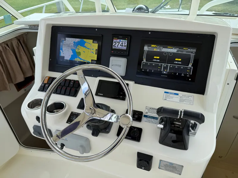 Slide: The Image of 2016 World Cat 320 EC helm with navigation system and controls. - 22
